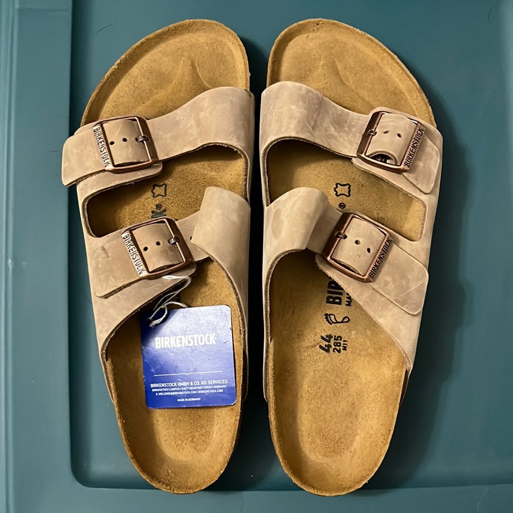Never worn, tags still on Men’s Birkenstocks size 44.